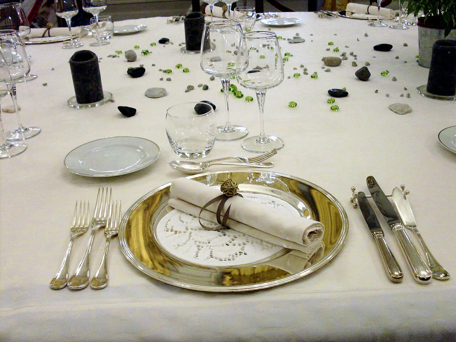 Cutlery and plates elegantly set on a white tablecloth