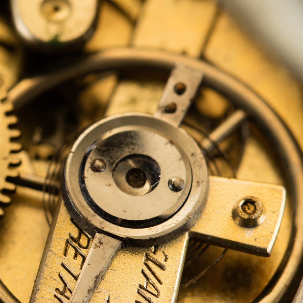 Macro view of a gilt watch balance wheel and gear train
