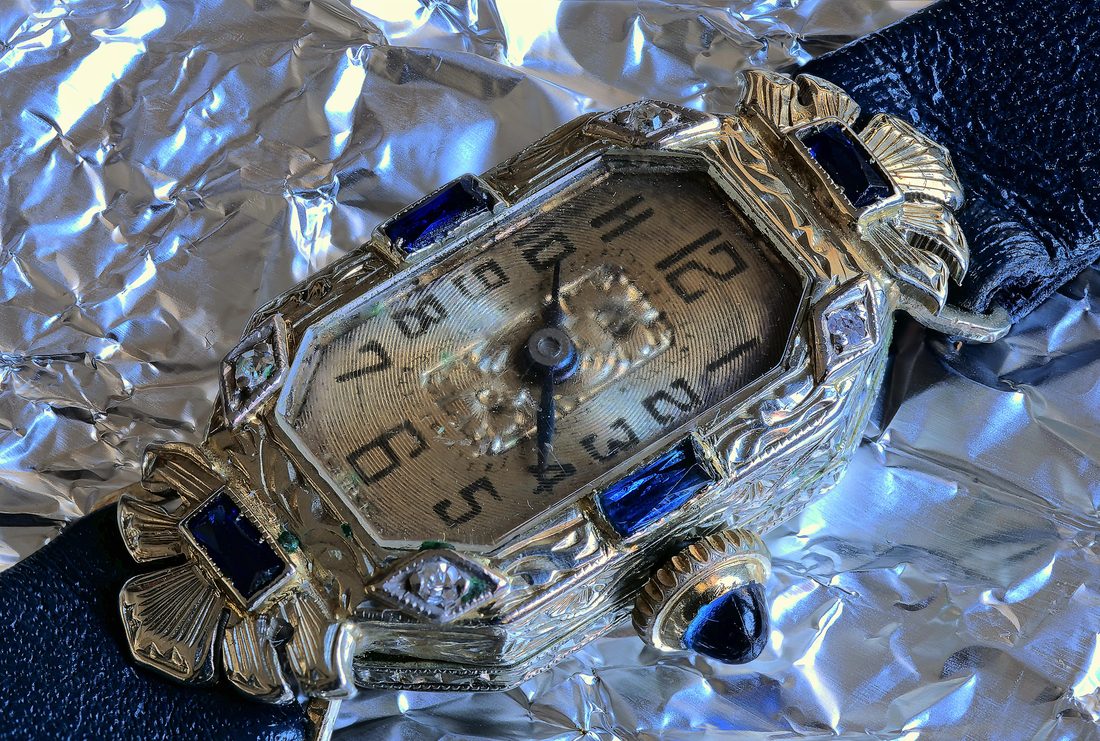 Art Deco cocktail wristwatch with sapphire-set case on a dark leather strap